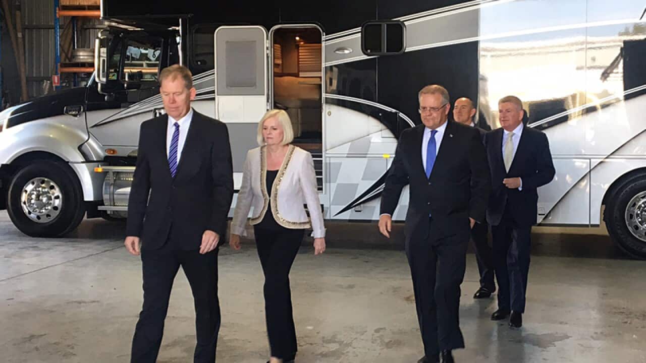 Treasurer Scott Morrison (2R) at an announcement on the Gold Coast