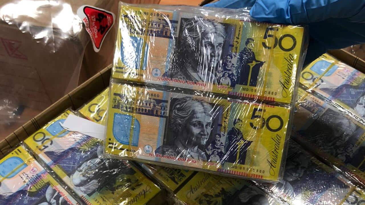 The Australian Federal Police shows off a seizure of imitation currency, known as 'joss paper', which is often used during Chinese New Year celebrations.