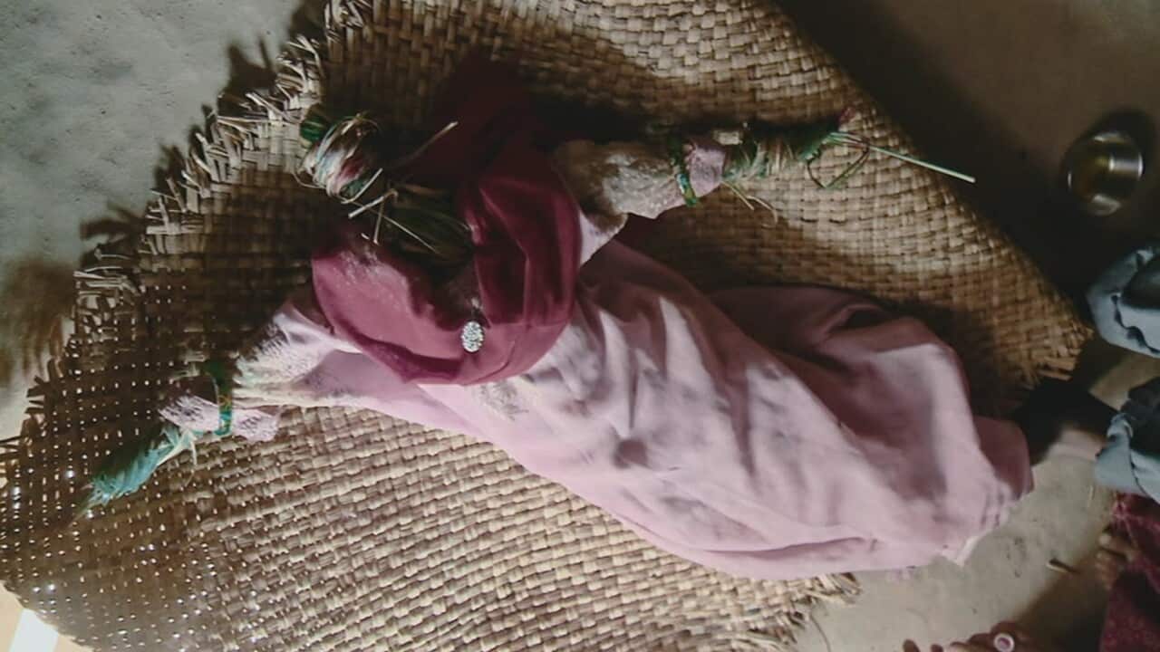 A doll signifying the missing person is prepared for funeral.