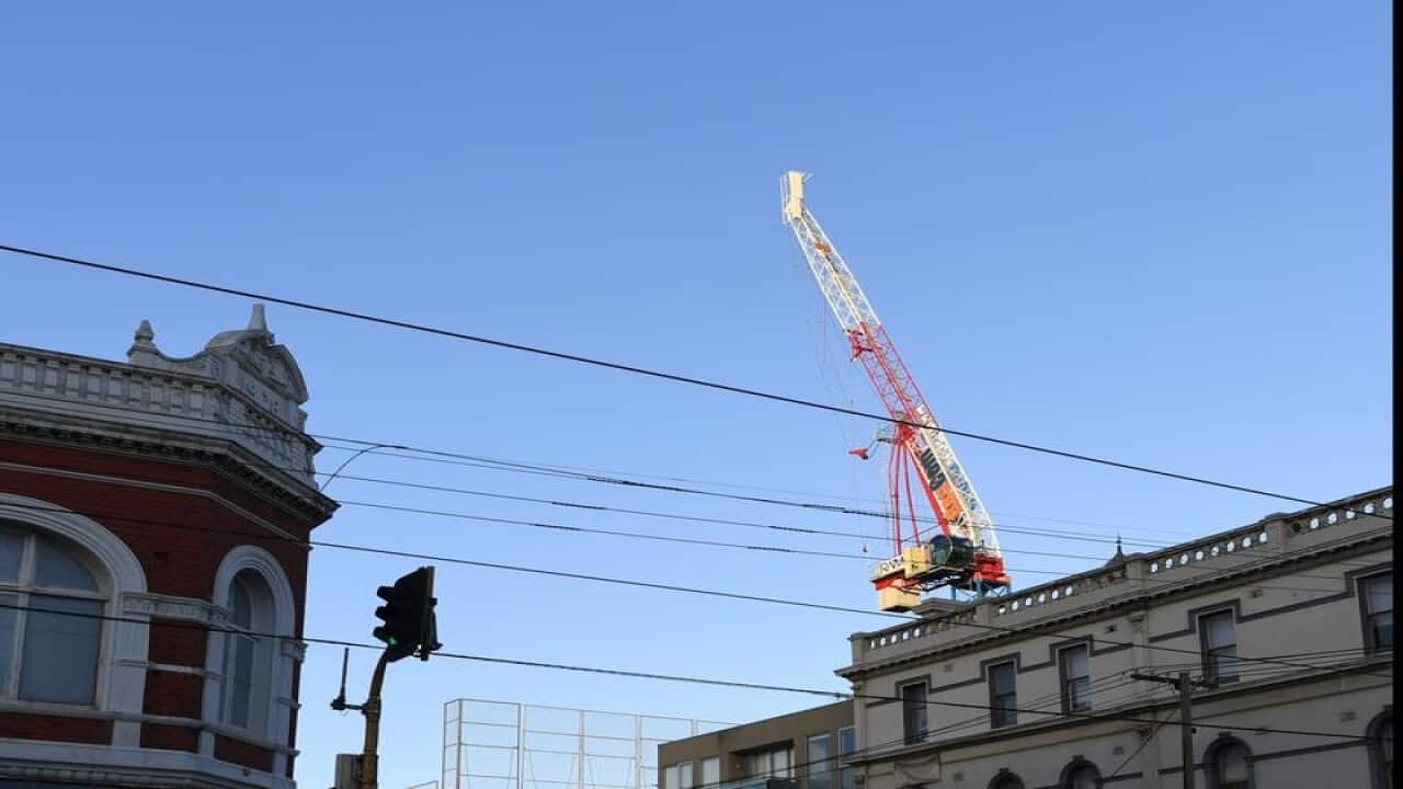 Emergency workers are taking down a damaged crane in Richmond.