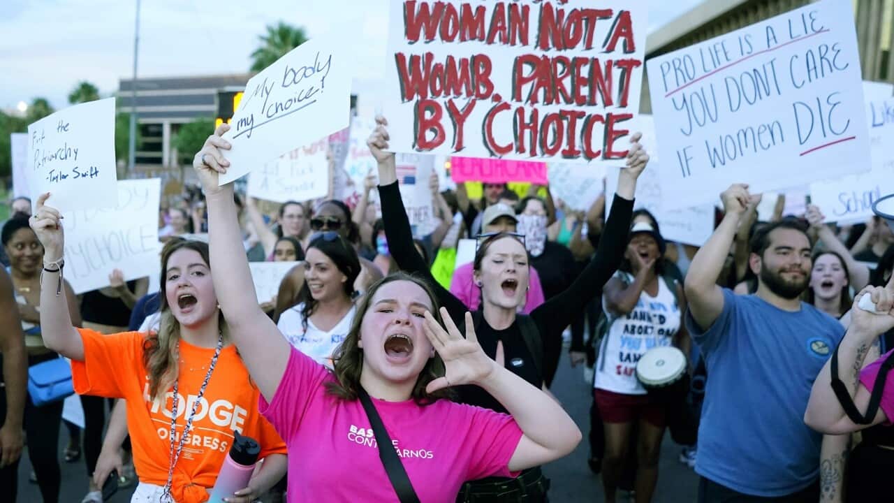 A group of protesters marching together, holding up signs with pro-choice messages.