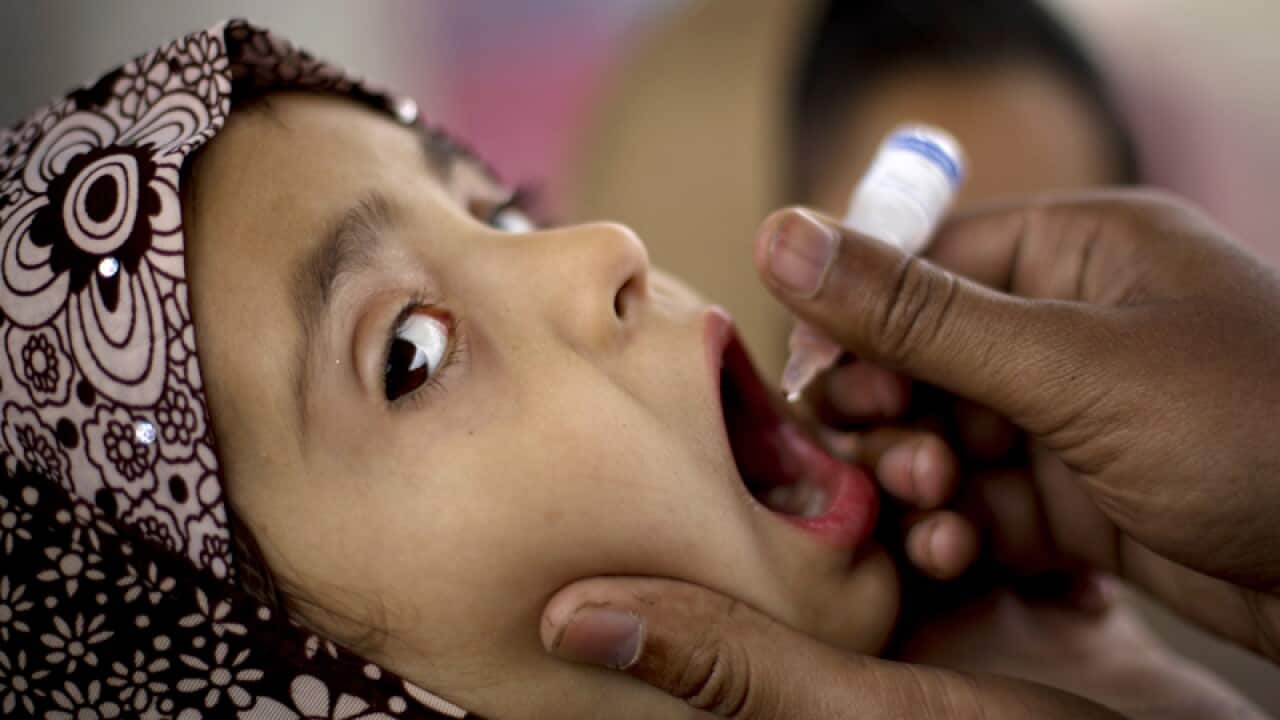 A Pakistani child is given a vaccination