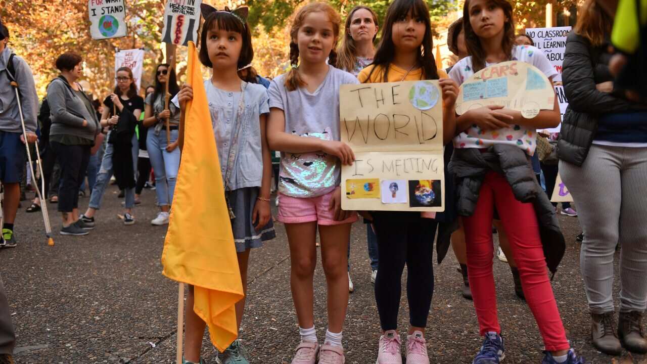 Up to a thousand people gather at Town Hall Square for a climate change protest before marching on to Hyde Park to join the Sorry Day rally outside New South Wales Parliament House in Sydney, Friday, May 24, 2019. (AAP Image/Dean Lewins) NO ARCHIVING