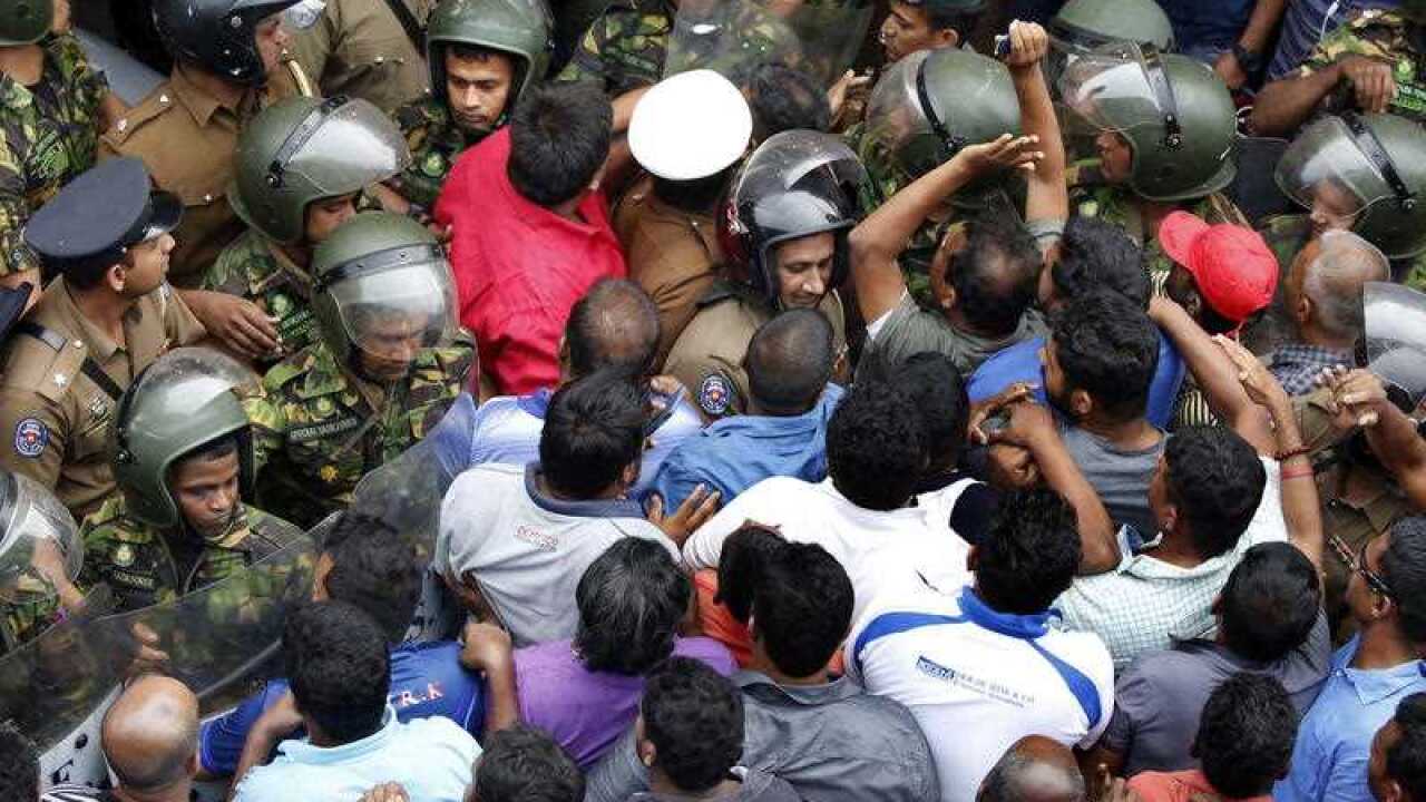 Sri Lanka Police Special Task Force personnel and protesters clash following the shooting. 