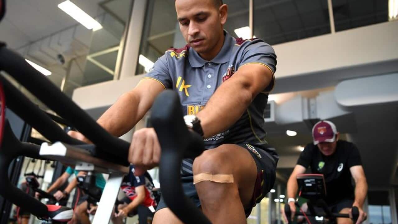 Usman Khawaja is seen on an exercise bike