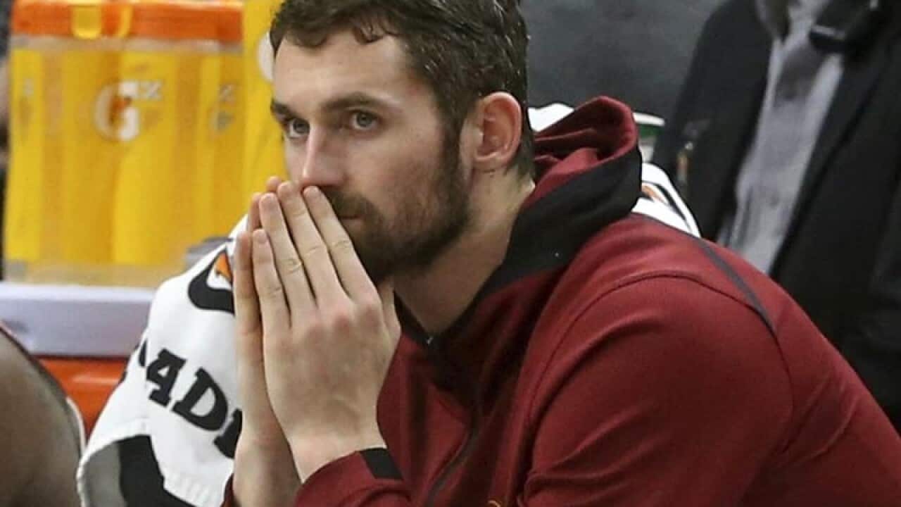Cavaliers' Kevin Love watches from the bench.