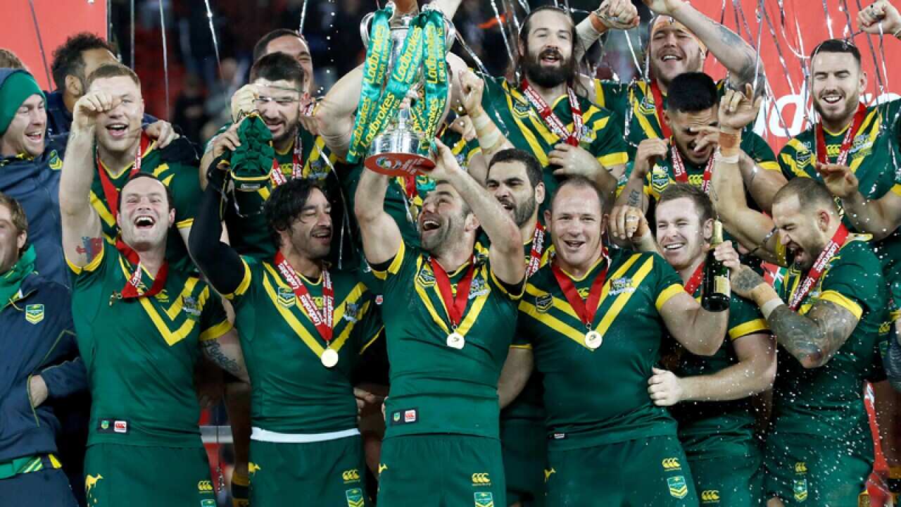 Australia's Cameron Smith (centre) lifts the trophy