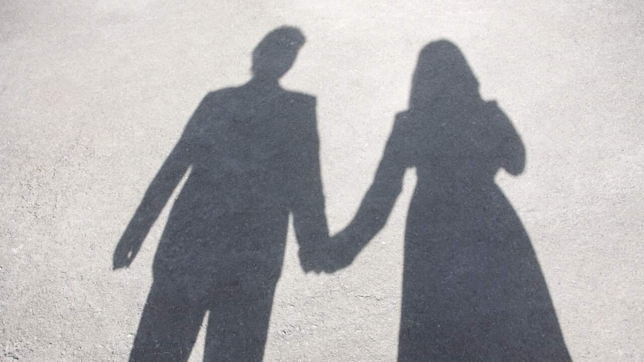 Shadow of couple holding hands, elevated view