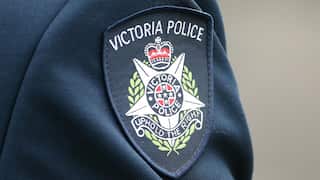 Victoria Police badge on a uniform up close