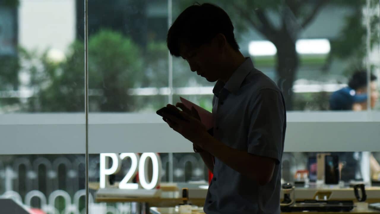 A man uses his mobile phone in Beijing.