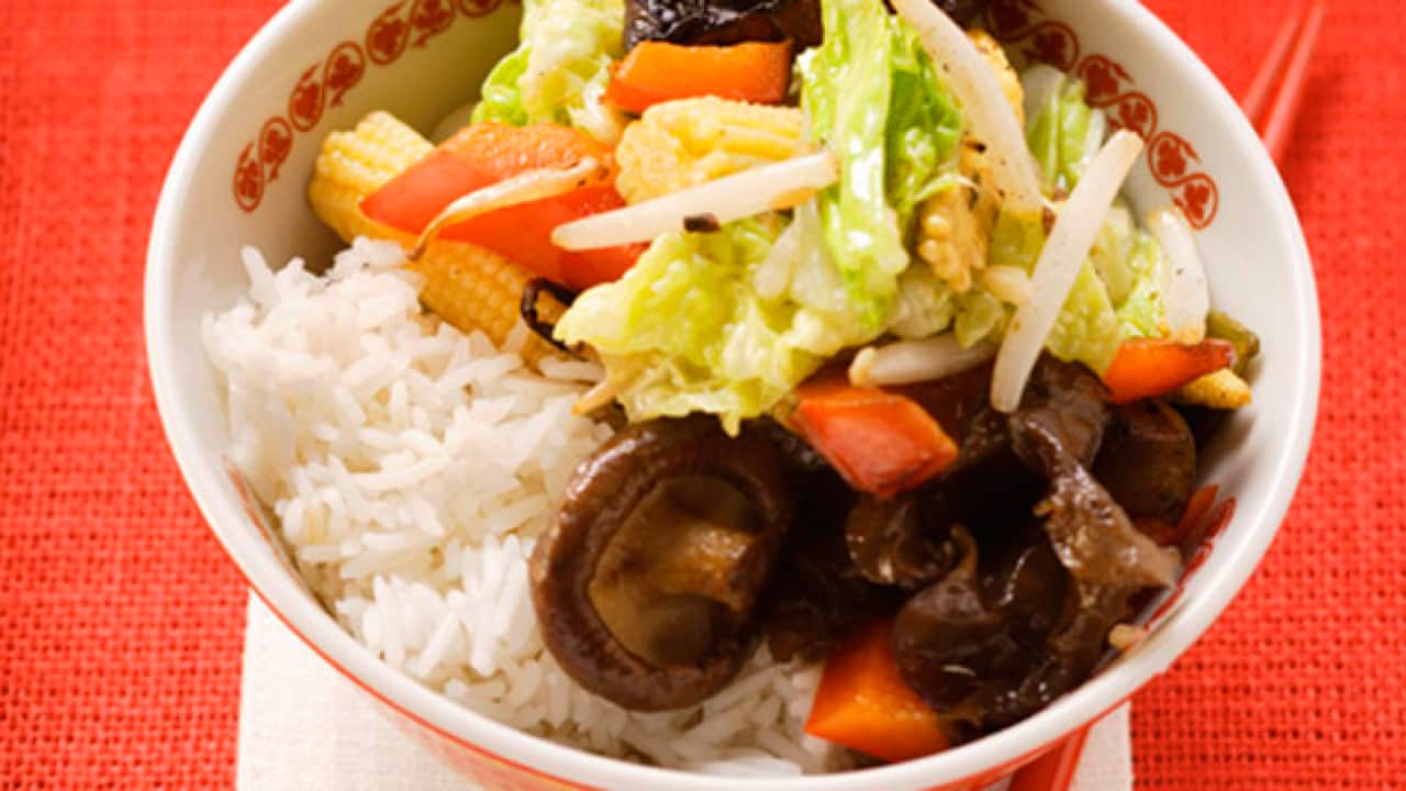 StockFood_00926421---Vegetables-and-mushrooms-cooked-in-wok-on-rice.png