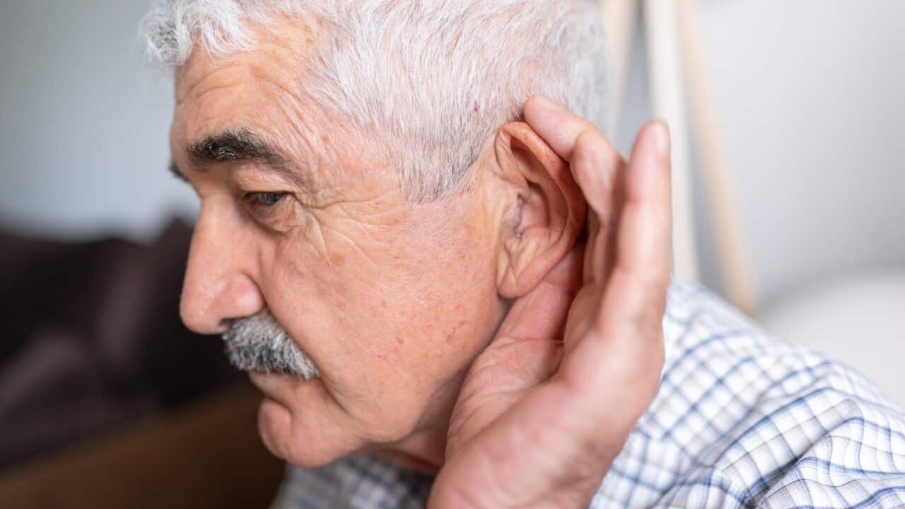 Senior Man Holding His Auricle With His Hand To Hear Well