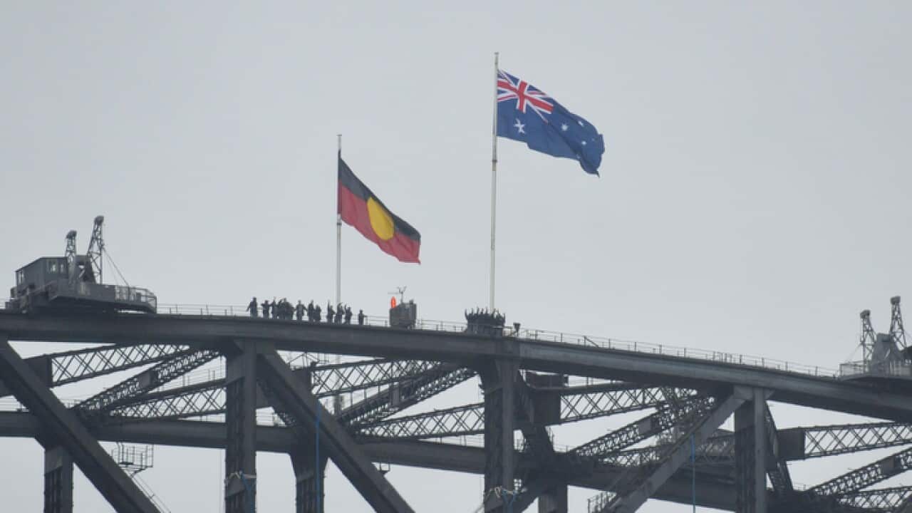 Australian and Aboriginal flags seen on the Harbour Bridge as part of Australia Day celebrations in Sydney, Monday, Jan. 26, 2015. (AAP Image/Joel Carrett) NN ARCHIVING