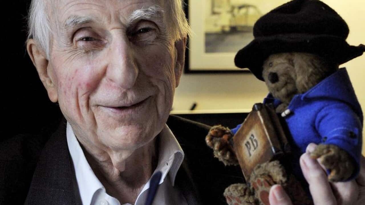 Michael Bond poses with a soft toy version of Paddington Bear