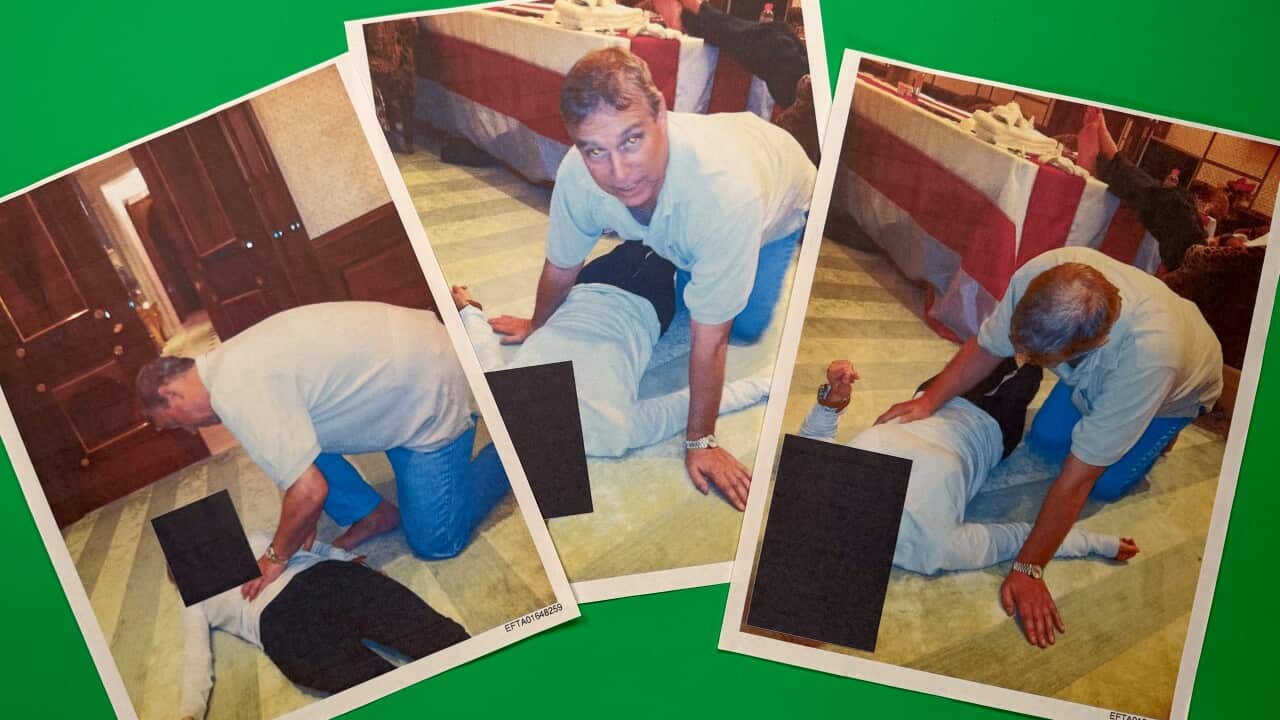 A middle-aged white man crouched on all four over an unidentified woman