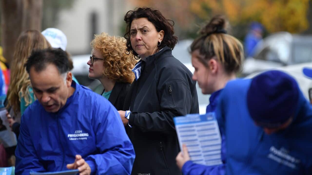 People are seen at an early voting centre.