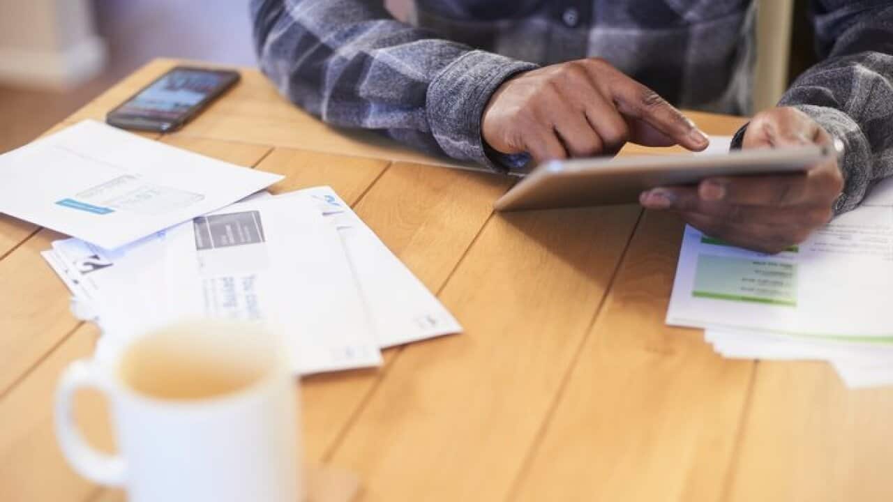 Person paying bills online with tablet
