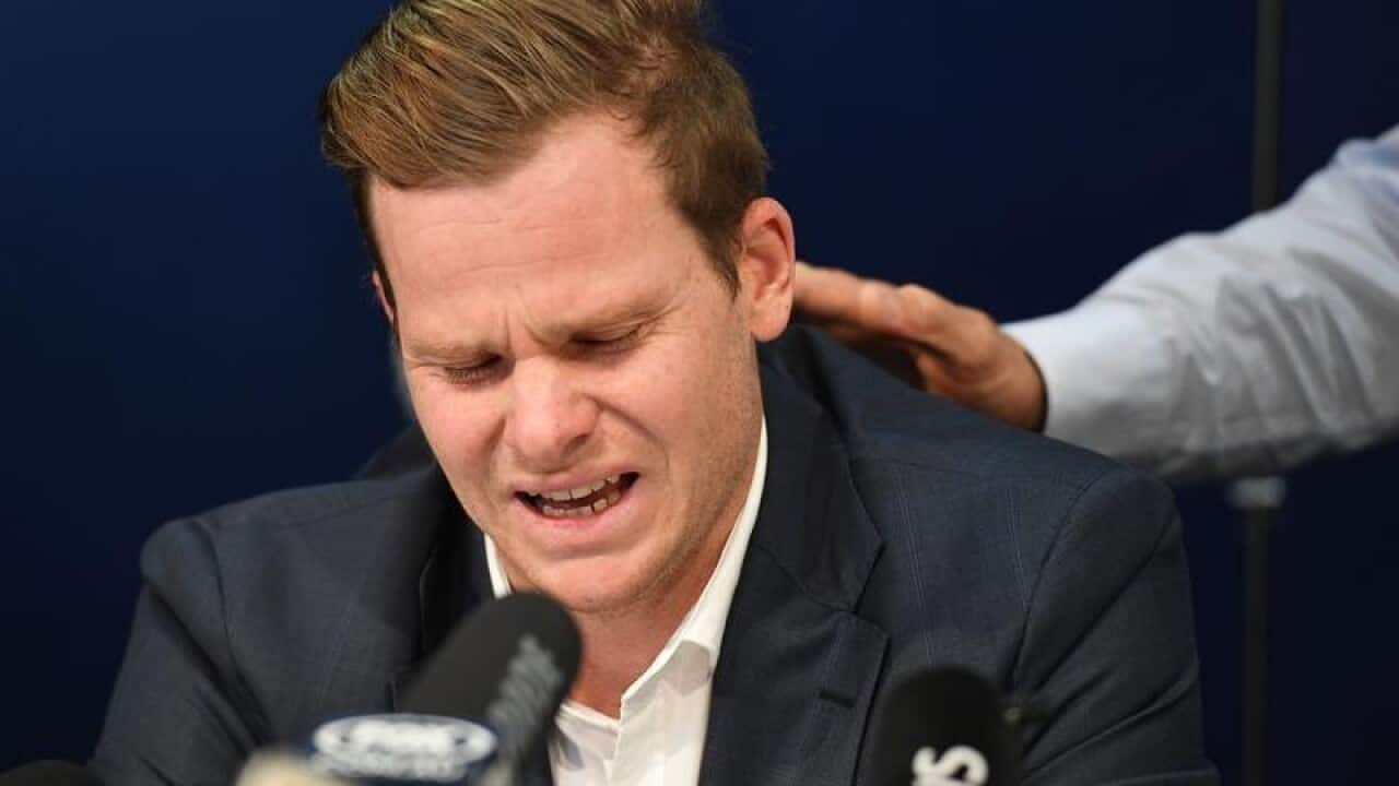 Disgraced Australian Cricket Captain Steve Smith (left) reacts.