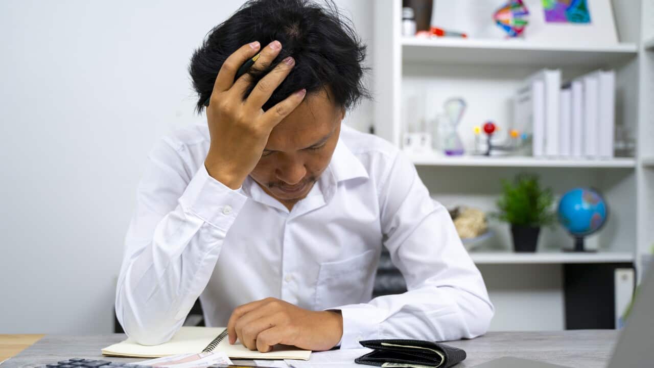 Man having financial problems with invoices and Credit Cards