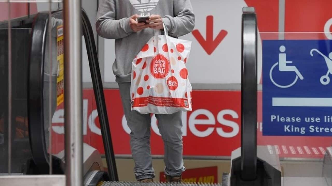 A shopper carrying a re-usable plastic bag at a Coles in Sydney
