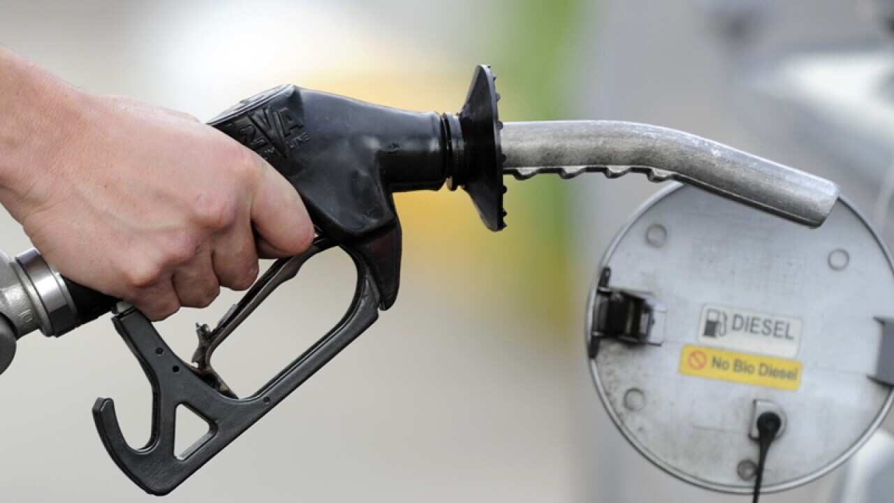 A man pumps petrol at a service station in Melbourne