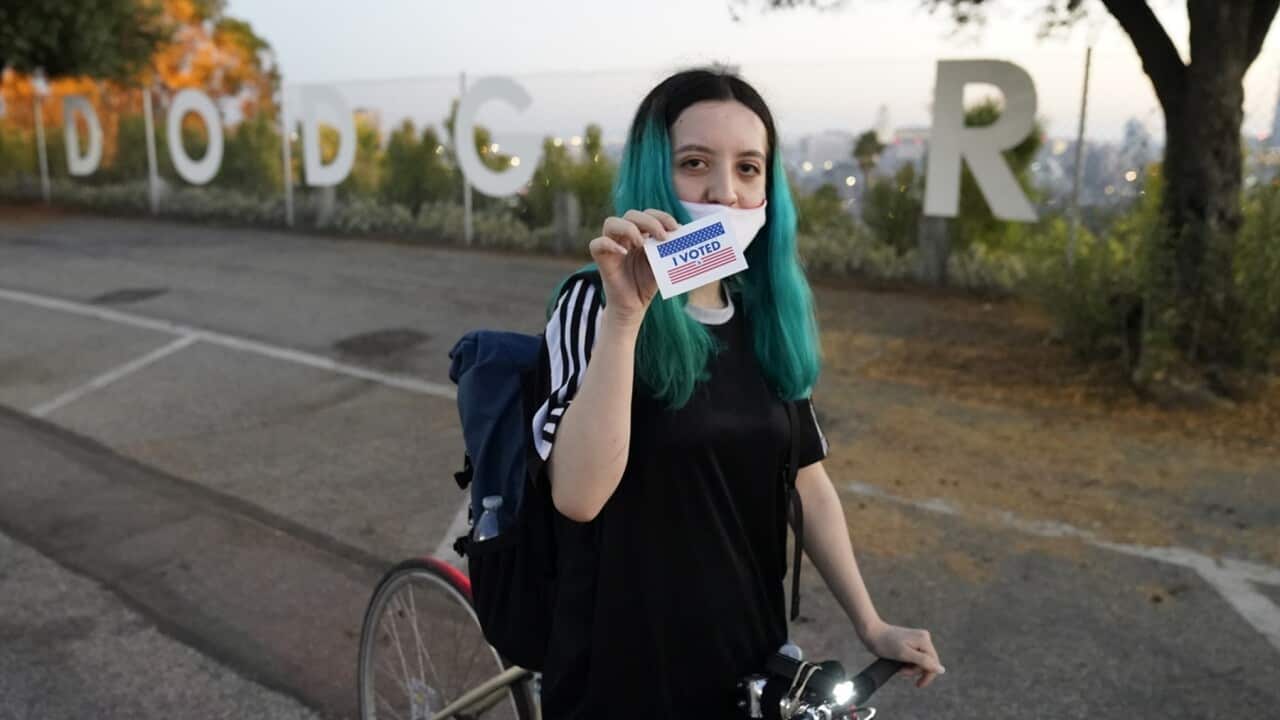 First time voter Wanda Carrillo, 23, from Los Angeles, shows her I Voted! sticker