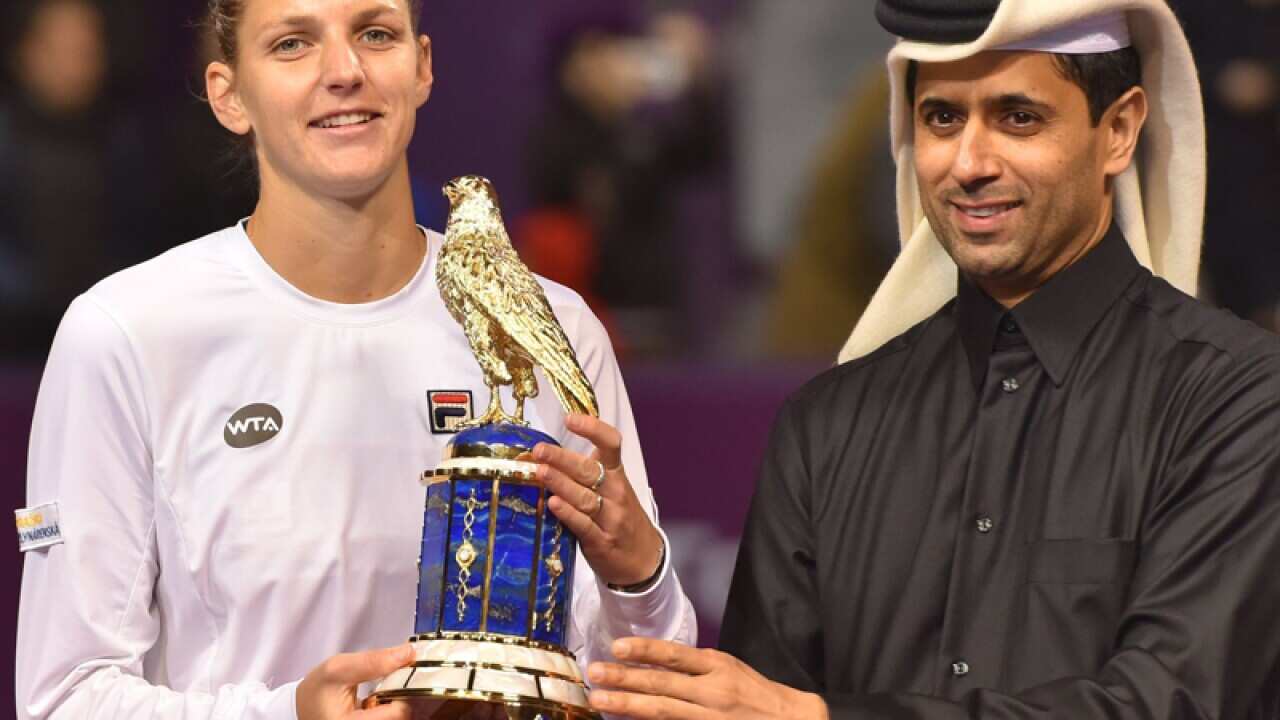 Karolina Pliskova (L) of Czech Republic receives her winning trophy