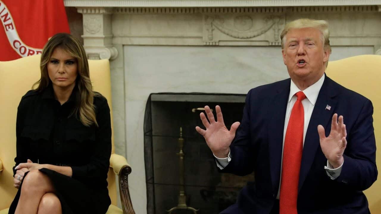 U.S. President Donald Trump talks to the media next to First Lady Melania Trump during a meeting about vaping in the the Oval Office at the White House.