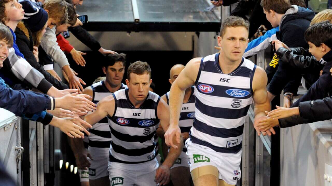 Joel Selwood of Geelong leads his side out against Hawthorn