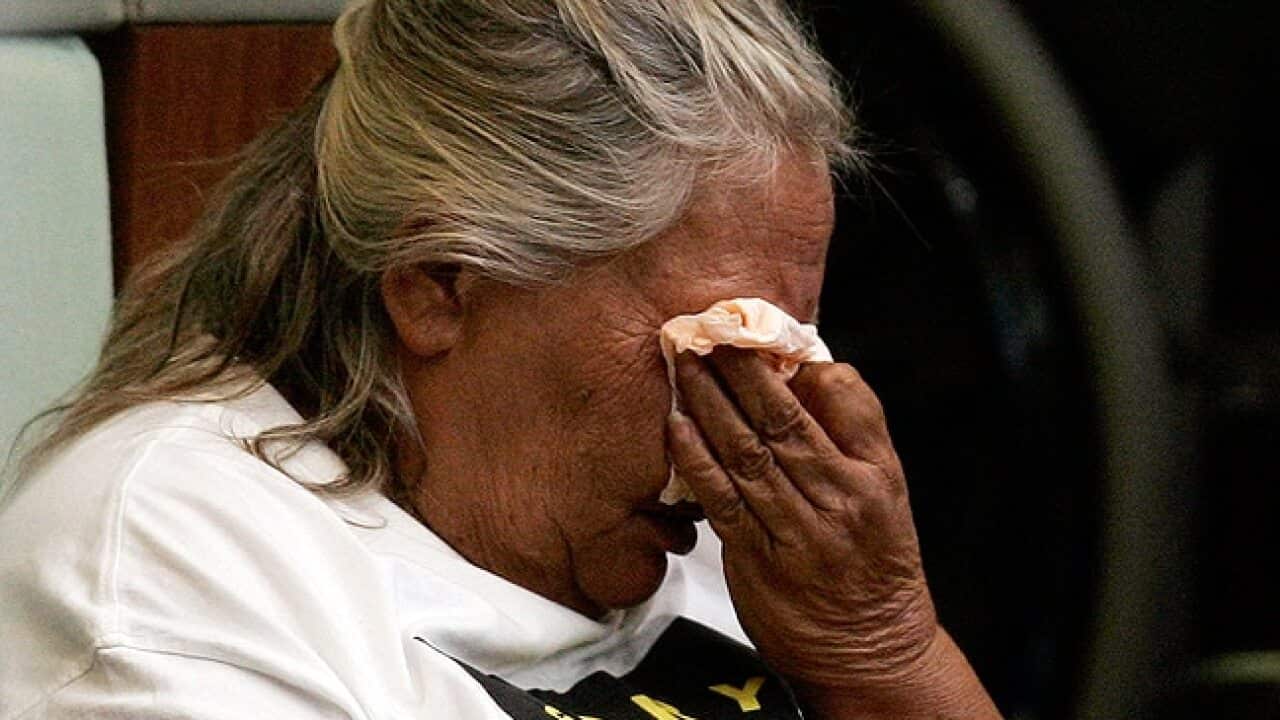 An Indigenous Australian woman cries in federal parliament as she listens to former prime minister Kevin Rudd deliver an apology to the Stolen Generations.