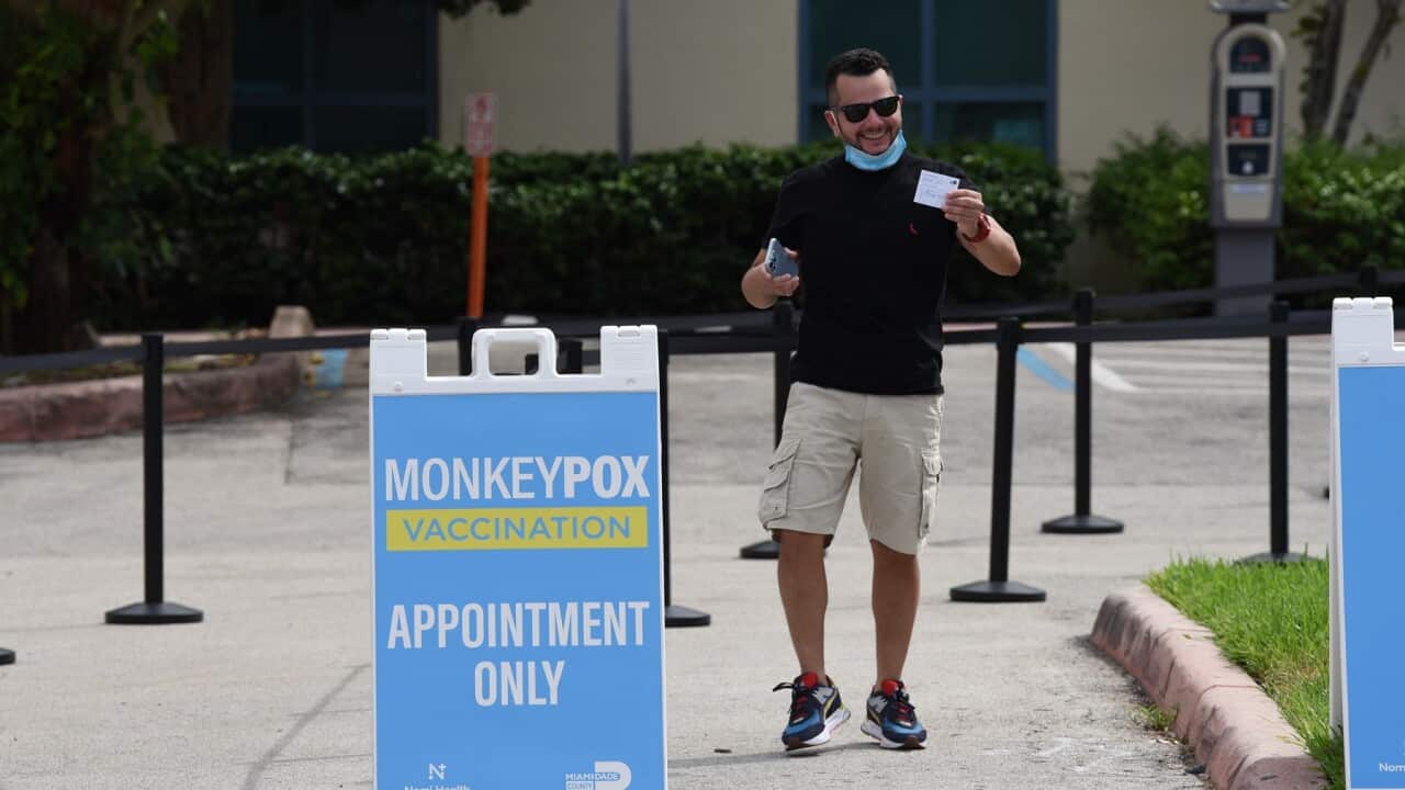 A man shows his Monkeypox vaccination card after getting inoculated in Miami-Dade Florida. (AAP)