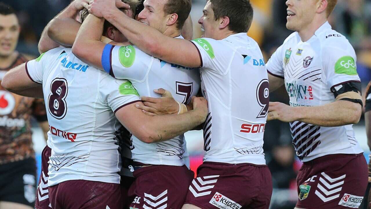 The Sea Eagles celebrate a try against the Warriors