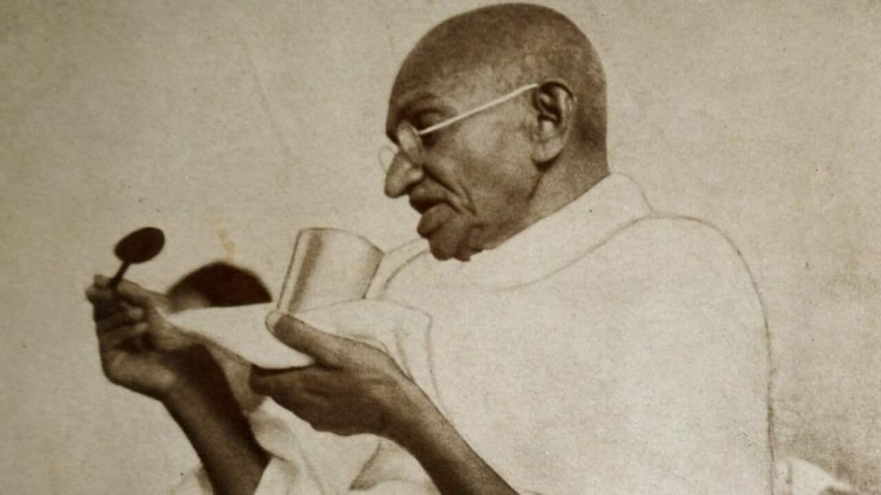 Mohandas Karamchand Gandhi takes a meal before a hunger strike.