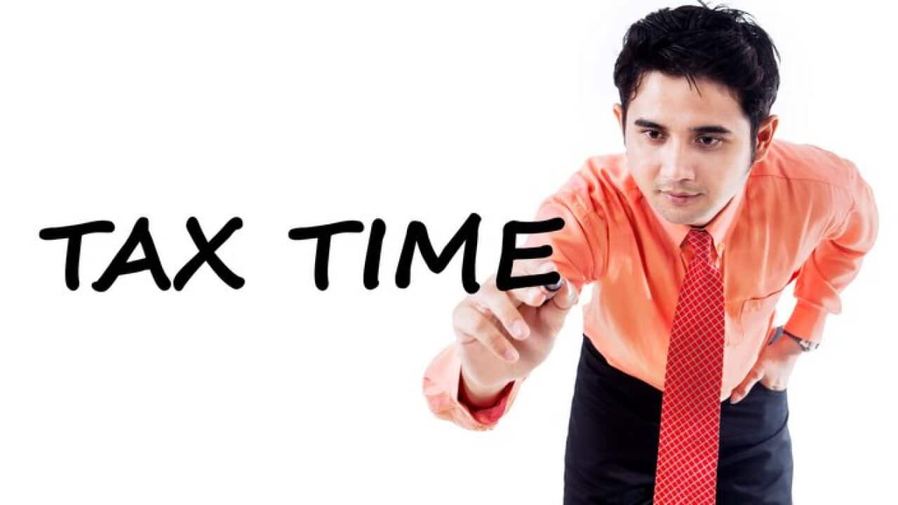 Male consultant writes tax time