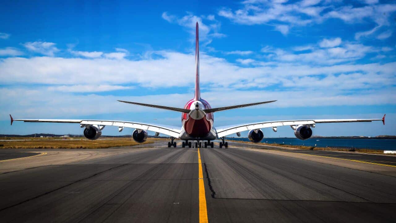 A plane on the runway at Sydney airport ready for takeoff.
