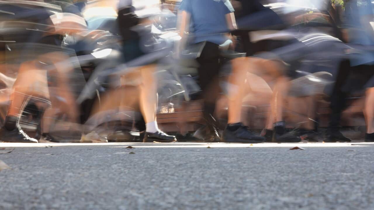 Busy school yard, pavement or footpath. Legs in motion