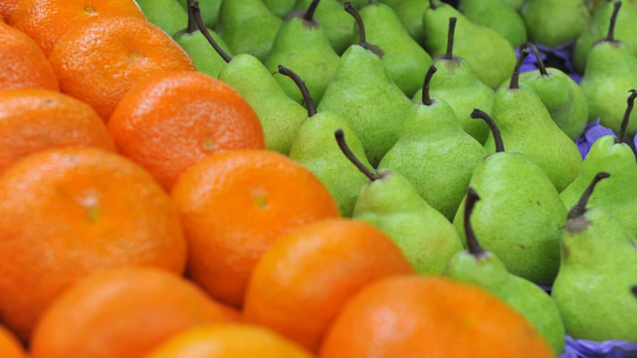 Oranges and pears in a stall at a fruit shore