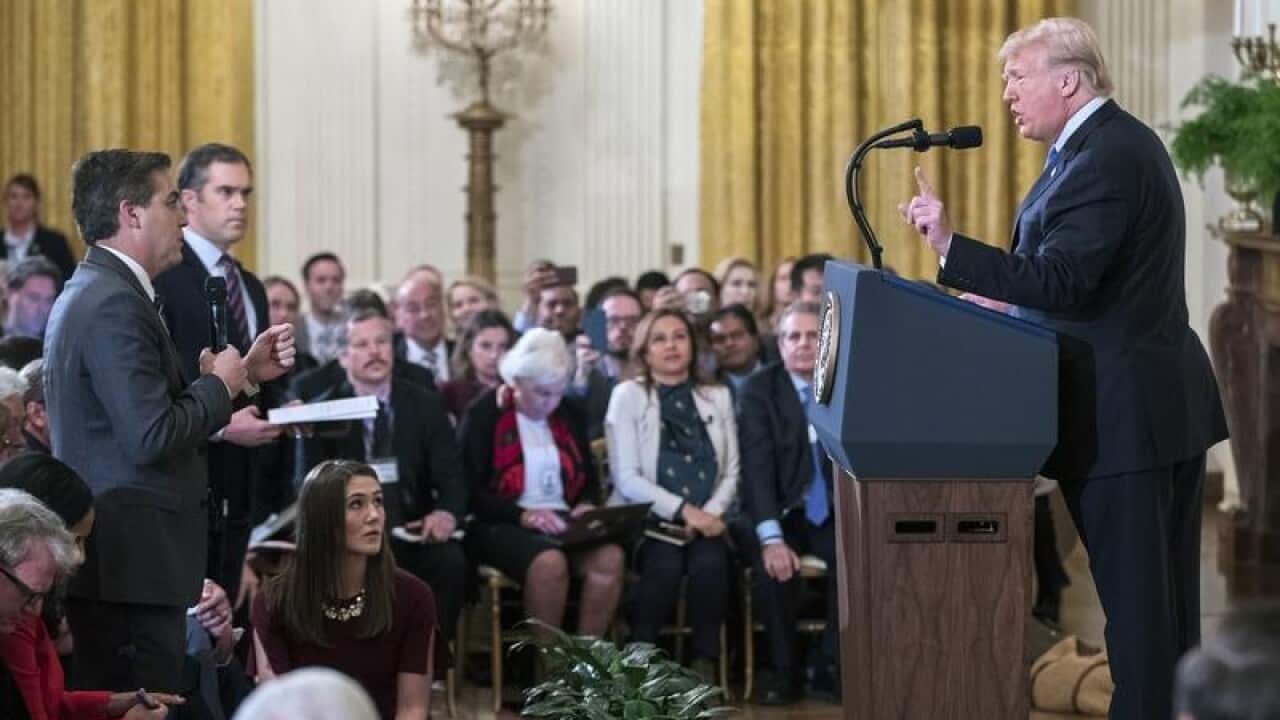 US President Donald Trump (R) and CNN reporter Jim Acosta (L)