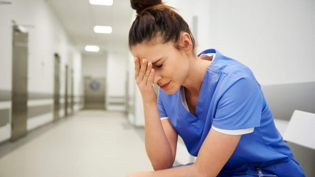 Female nurse suffering from headache