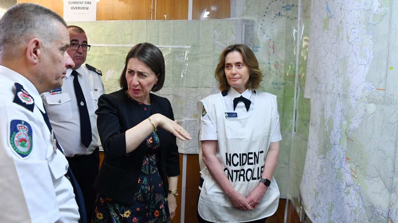 New South Wales Premier Gladys Berejiklian is briefed by NSW Rural Fire Service Deputy Commissioner Rob Rogers and RFS Superintendent Karen Hodges.