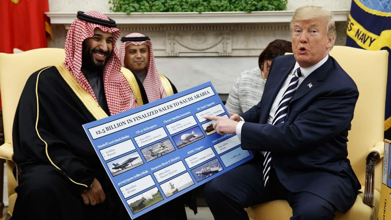 President Donald Trump shows a chart highlighting arms sales to Saudi Arabia during a meeting with Saudi Crown Prince Mohammed bin Salman.