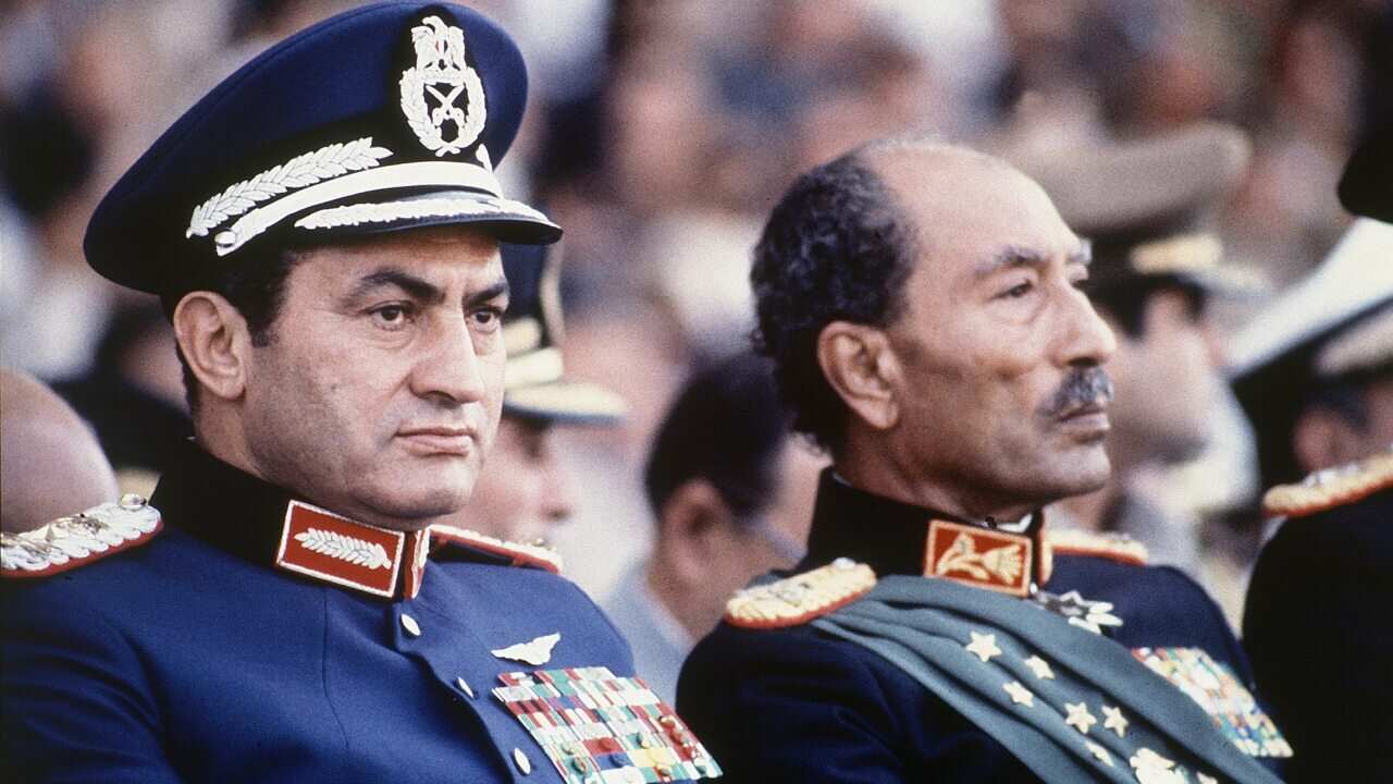 President Anwar Sadat, right, and Vice President Hosni Mubarak watch a parade just before soldiers opened fire, killing President Sadat.