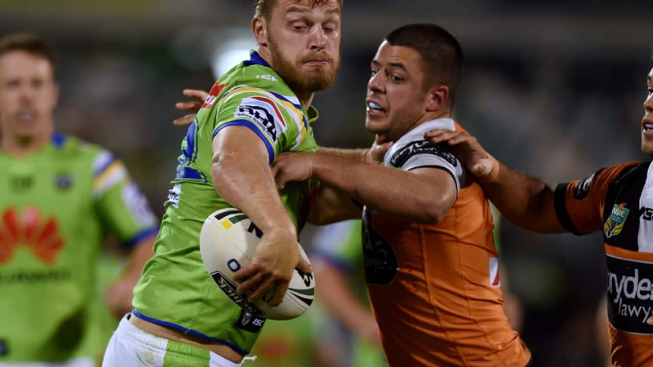 Elliot Whitehead of the Raiders (left) Nathan Milone of the Tigers