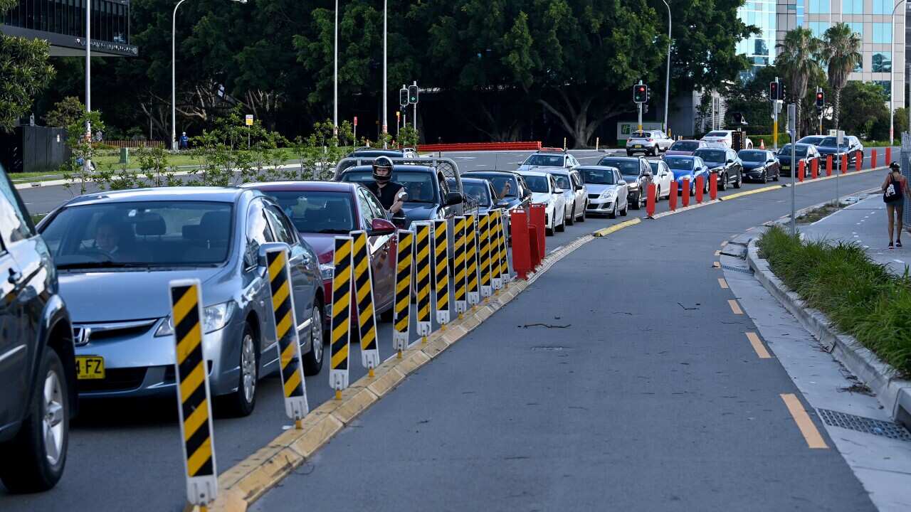 Members of the public queue in their cars for a COVID-19 PCR test at the Mascot Laverty Pathology Drive-through Clinic in Sydney.