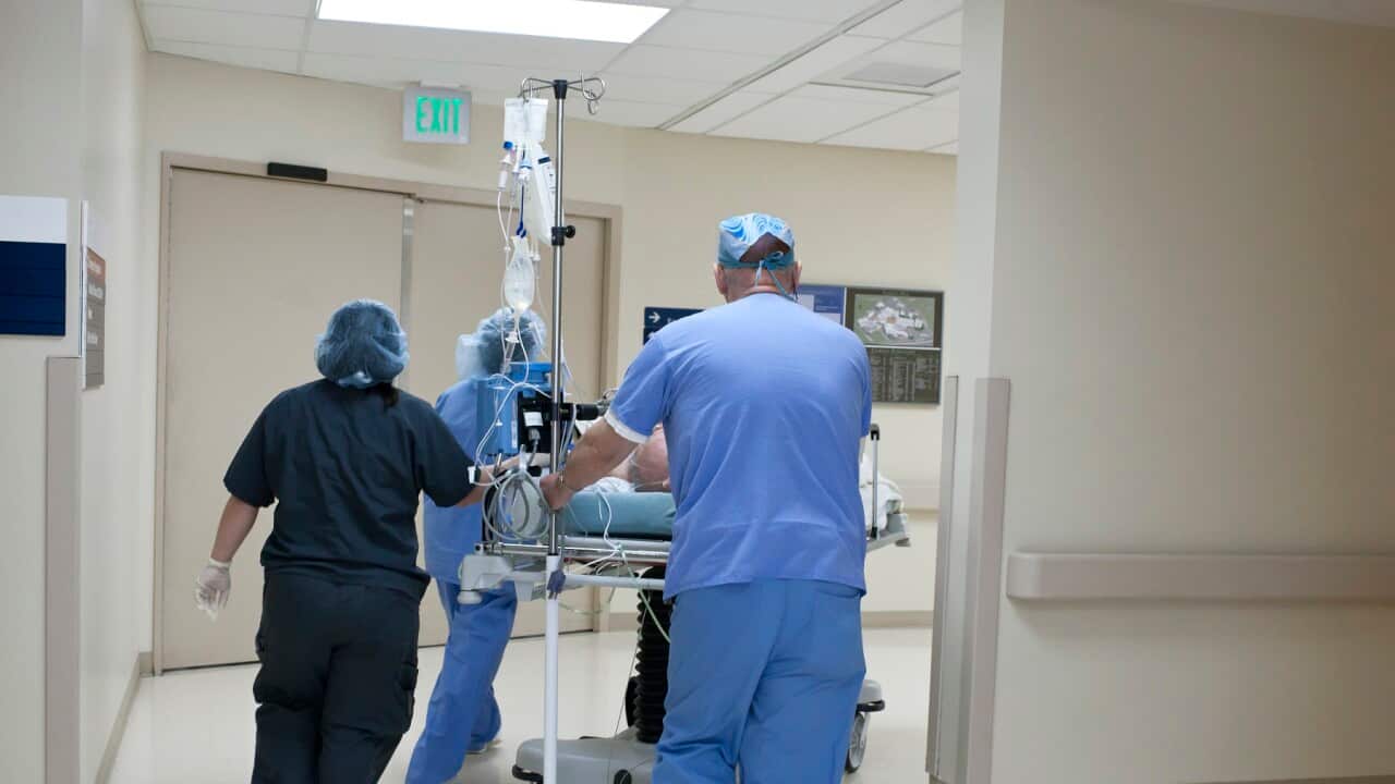 Patient being rushed through hospital corridor