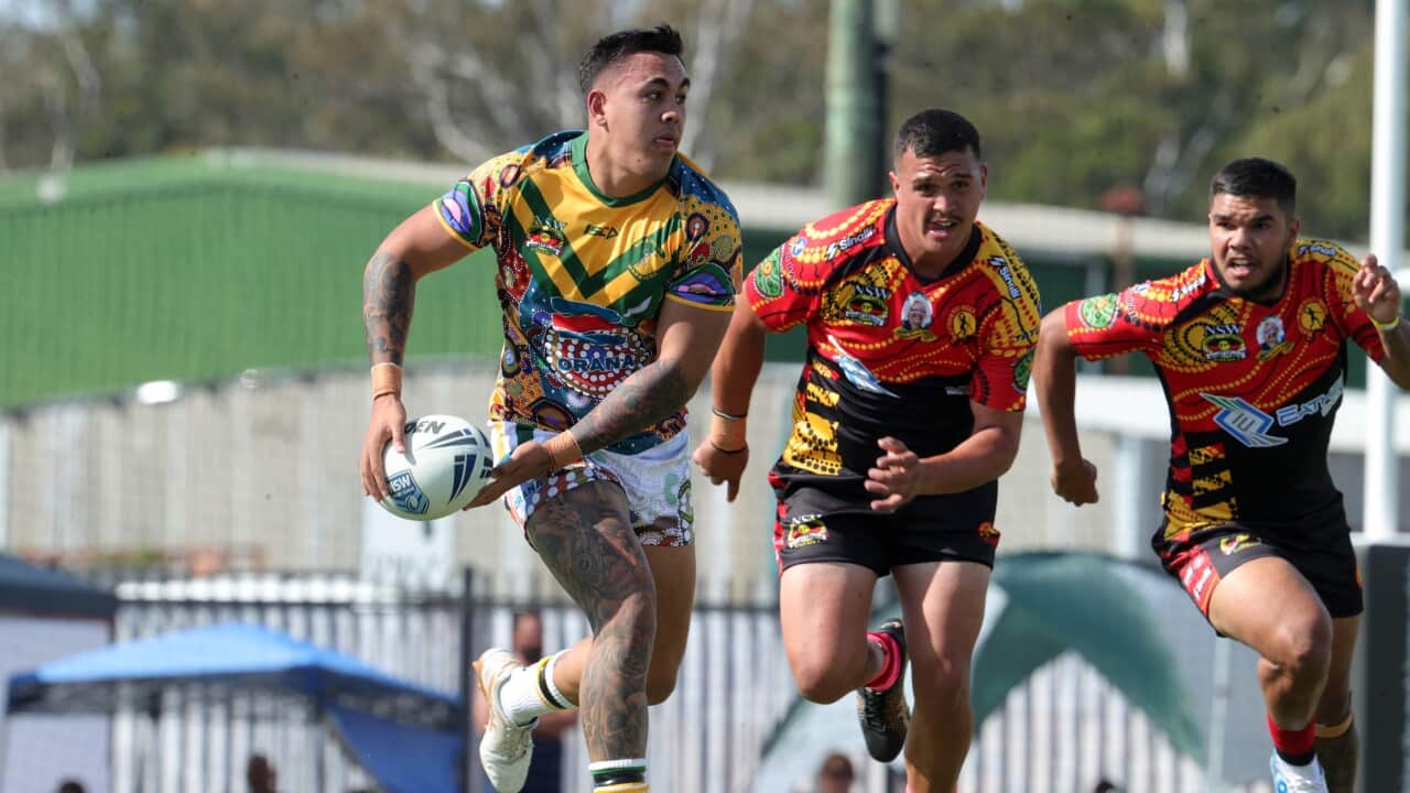 A player runs with the ball at a Koori Knockout match