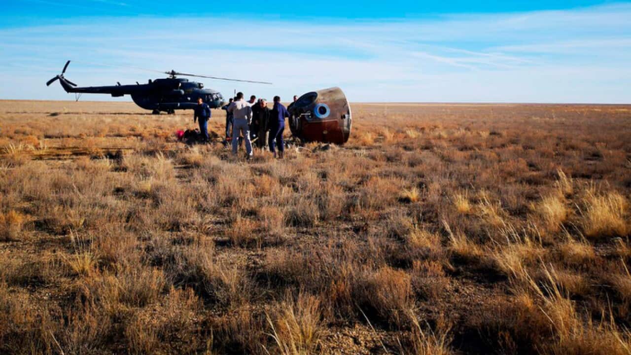 The rescue team next to the Soyuz MS-10 space capsule after it made an emergency landing in Kazakhstan