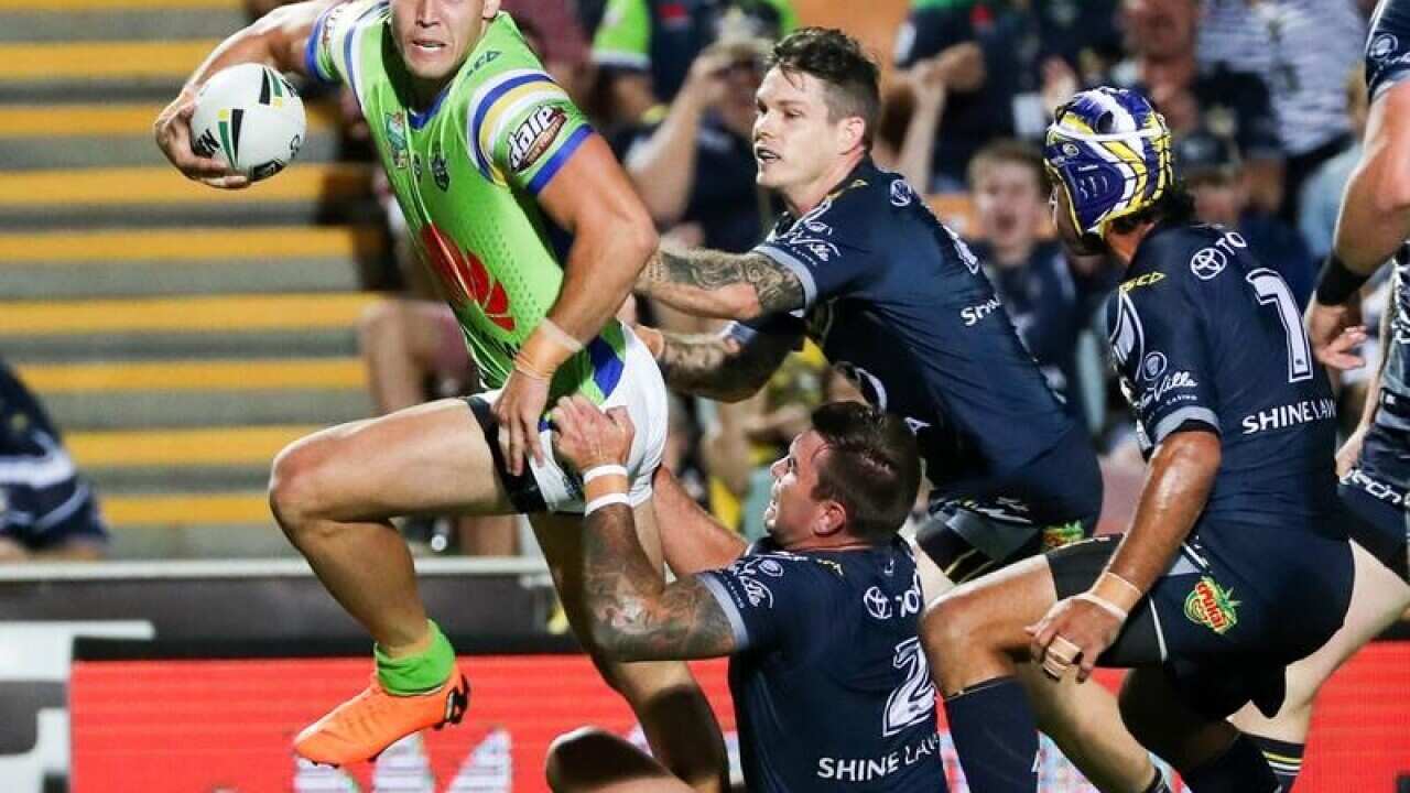 Nick Cotric of the Raiders attempts to break away from Cowboys defence