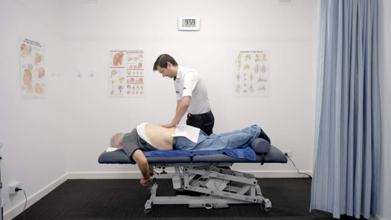 Robert Salerno massaging an elderly client.