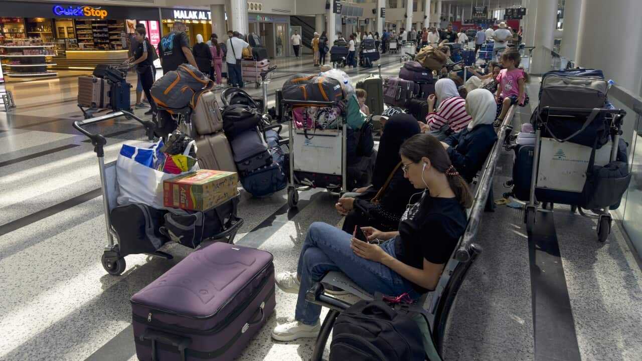 Passengers wait after their flights were delayed or canceled at Rafik Hariri International Airport, in Beirut, (AAP)